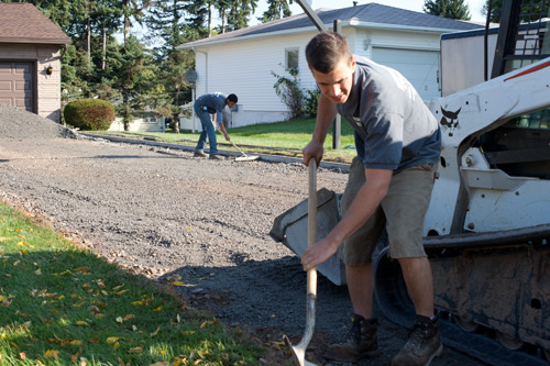 a picture of ryan and a worker preping the base for a concrete driveway pour